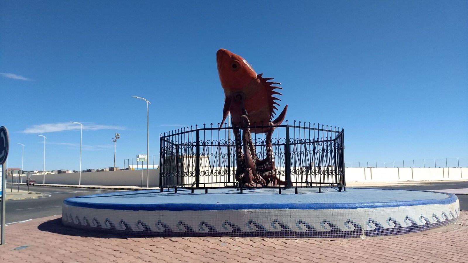 A fish bids to escape the outstretched tentacles of an octopus astride of the increasingly absurd roundabouts found on the road south from Layoune